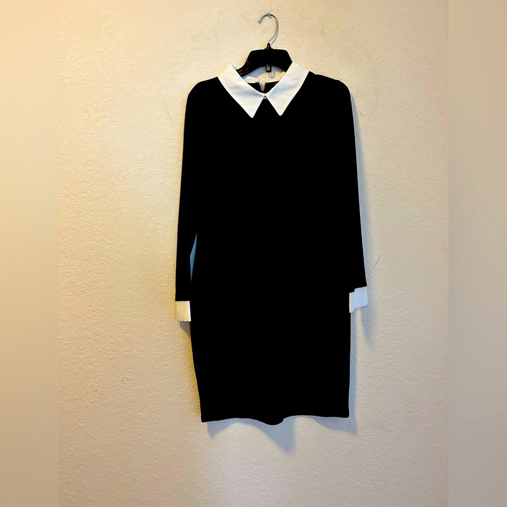 Super cute mini suit dress dress this up with a necklace or a neck tie or bow.